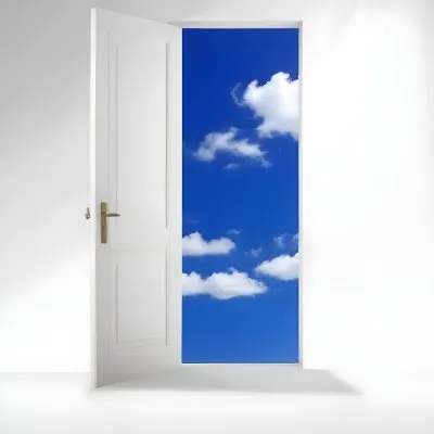 A White Door Opening To A Bright Blue Sky